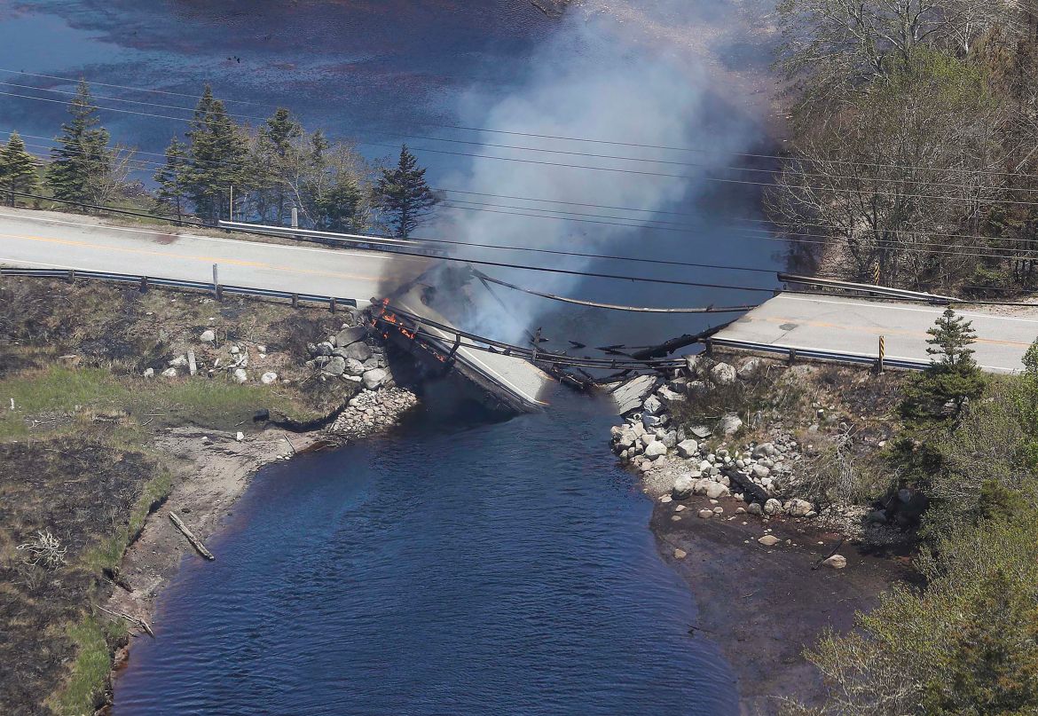 the collapsed bridge between Clyde River and Port Clyde smoulders. - Firefighters on May 31, faced a grueling uphill battle against wildfires in Canada's Nova Scotia province, including one threatening suburbs of Halifax. Federal help was coming, officials said, along with firefighters from the United States.