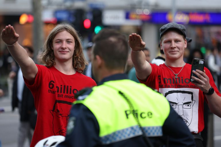 Members of the National Socialist Network perform Nazi salutes during a protest rally in Melbourne on June 4 2023. (Photo by Martin KEEP / AFP)