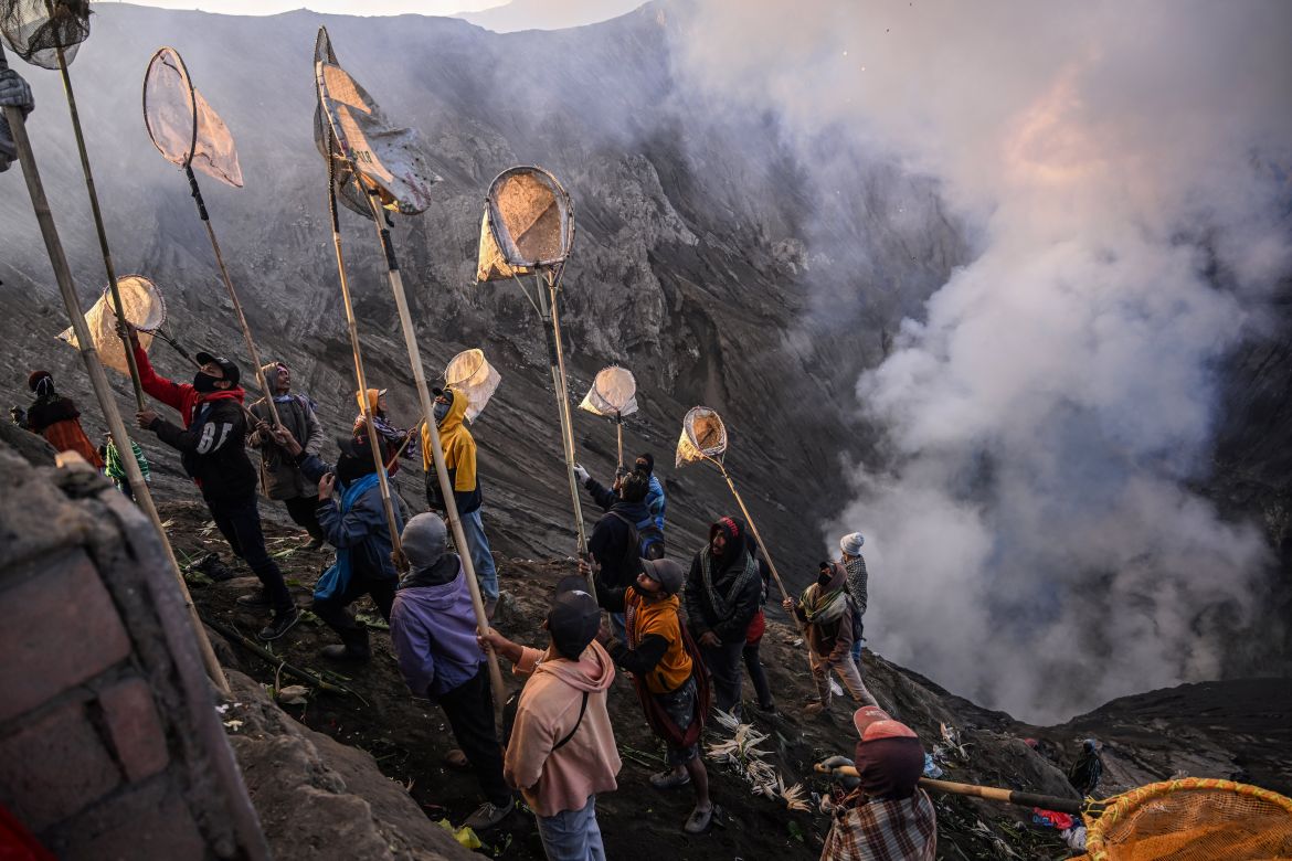 Villagers use nets to catch offerings thrown by members of the Tengger sub-ethnic group in the crater of the active Mount Bromo volcano as part of the Yadnya Kasada festival in Probolinggo