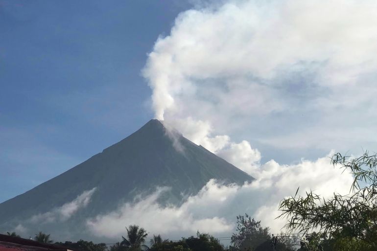 This handout photo made available by Kristin Moral shows the Mount Mayon spewing white smoke as seen from Camalig on June 8, 2023 - Hundreds of families living around Mount Mayon in central Albay province are expected to be moved to safer areas after the Philippine Institute of Volcanology and Seismology raised a "hazardous eruption" alarm. (Photo by Handout / Kristin Moral / AFP) / RESTRICTED TO EDITORIAL USE - MANDATORY CREDIT "AFP PHOTO / KRISTIN MORAL" - NO MARKETING NO ADVERTISING CAMPAIGNS - DISTRIBUTED AS A SERVICE TO CLIENTS - RESTRICTED TO EDITORIAL USE - MANDATORY CREDIT "AFP PHOTO / Kristin Moral" - NO MARKETING NO ADVERTISING CAMPAIGNS - DISTRIBUTED AS A SERVICE TO CLIENTS /