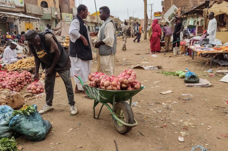 People gather at a market to buy food provisions, in Khartoum on June 10, 2023