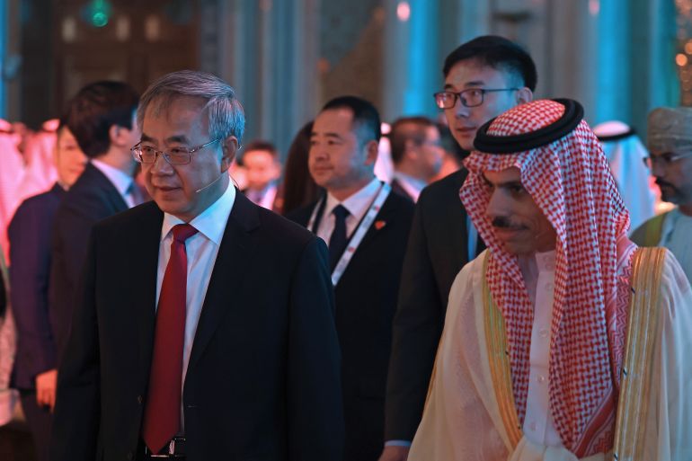 Saudi Foreign Minister Faisal bin Farhan al-Saud (R) and Vice Chairman of the Chinese People's Political Consultative Conference