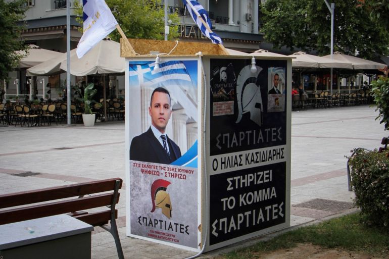 A kiosk of far right party's Spartiates (Spartans) showing a portrait of former ultra-nationalist Golden Dawn party spokesman, Ilias Kasidiaris, who is sentenced to 13-and-a-half years in prison as a member of a criminal organization, with the words, 'Ilias Kasidiaris supports the party Spartiates', is erected on a square in southern Greek city of Kalamata