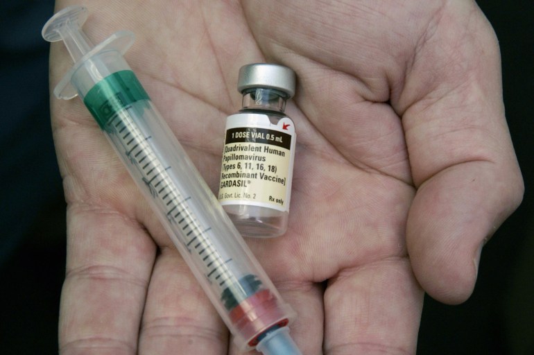FILE - In this Aug. 28, 2006 file photo, a doctor holds a vial of the human papillomavirus (HPV) vaccine Gardasil in his Chicago office. A national estimate suggests that nearly half of U.S. men have mostly silent infections caused by the sexually-transmitted human papilloma virus, and that 1 in 4 has strains linked with several cancers. The study was released Thursday, Jan. 19, 2017. (AP Photo/Charles Rex Arbogast, File)