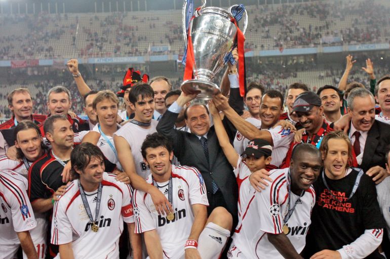 AC Milan's Silvio Berlusconi raises Champions League trophy aloft with the team