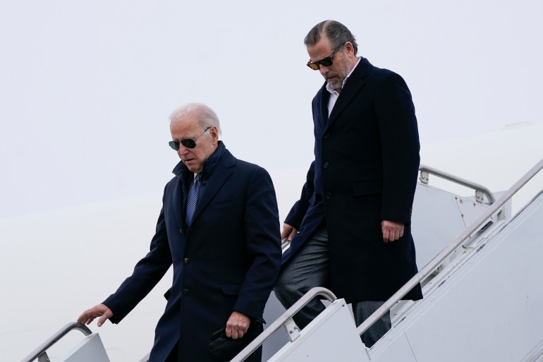 President Joe Biden, followed by his son, descend the staircase leading away from Air Force One on February 4, 2023