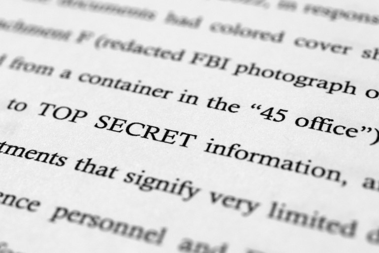 A close-up of a document that reads "top secret" in all capital letters.