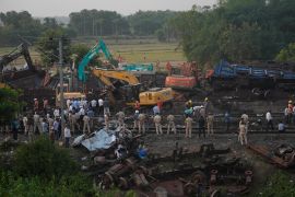 Policemen stand guard at the site where trains that derailed, in Balasore district, in the eastern Indian state of Orissa, Sunday, June 4, 2023. Indian authorities end rescue work and begin clearing mangled wreckage of two passenger trains that derailed in eastern India, killing over 300 people and injuring hundreds in one of the country’s deadliest rail crashes in decades. (AP Photo/Rafiq Maqbool)