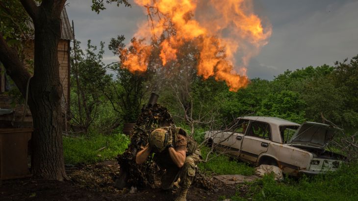 A Ukrainian soldier fires a mortar at Russian positions on the frontline near Bakhmut, Donetsk region
