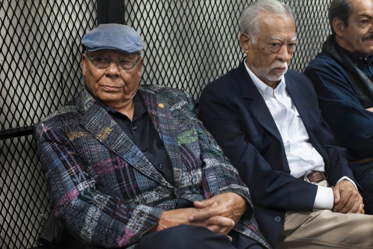 FILE - Former army officers Benedicto Lucas Garcia, left, and Edilberto Letona Linares, sit in a cell at a courtroom in Guatemala City, Thursday, March 2, 2017