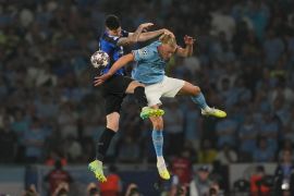 Inter Milan&#39;s Alessandro Bastoni, left, heads the ball past Manchester City&#39;s Erling Haaland during the Champions League final soccer match between Manchester City and Inter Milan at the Ataturk Olympic Stadium in Istanbul, Turkey, Saturday, June 10, 2023. (AP Photo/Antonio Calanni)