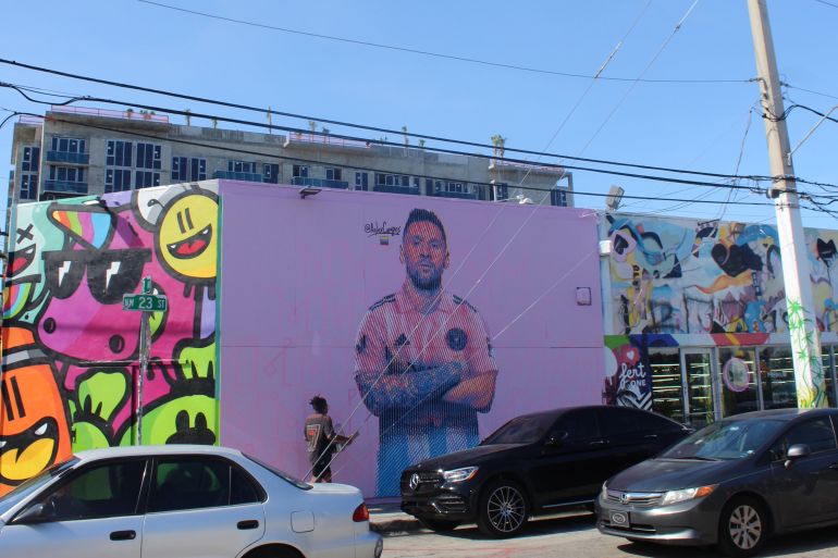 A mural of Messi in a pink shirt