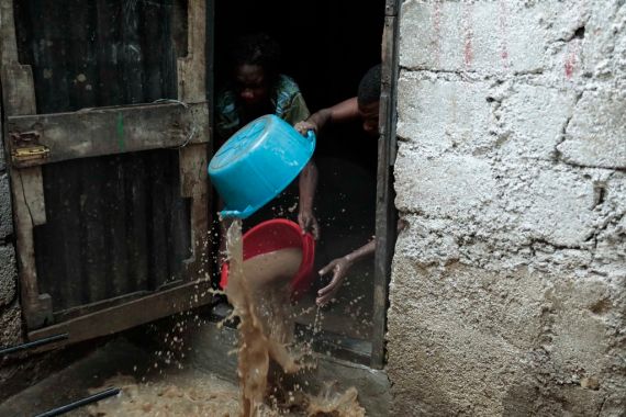 People toss water out of their homes with a bucket
