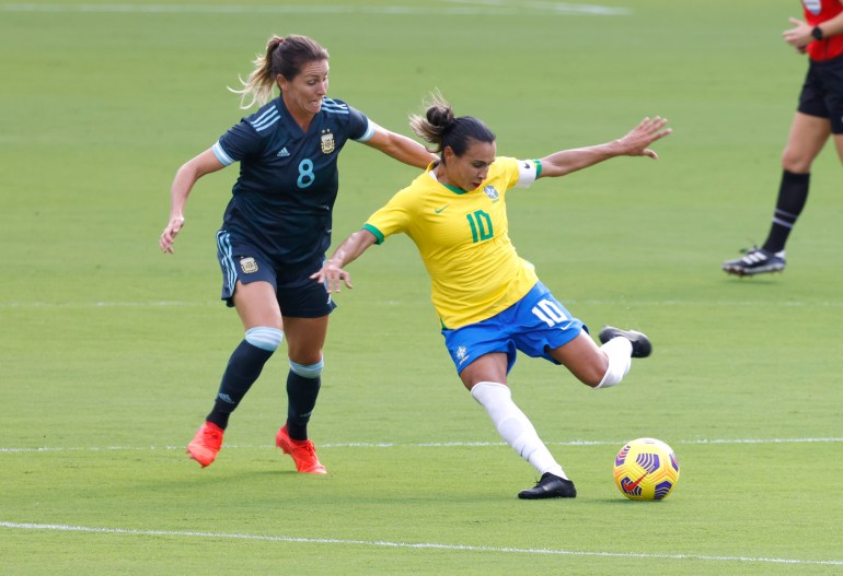 Feb 18, 2021; Orlando, Florida, USA; Brazil midfielder Marta (10) works the ball in front of Argentina midfielder Clarisa Huber 
