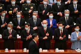 Delegates including China&#39;s ex-Foreign Minister Qin Gang (front row, second from the right) applaud as China&#39;s President Xi Jinping arrives for the closing session of the National People&#39;s Congress at the Great Hall of the People in Beijing on March 13, 2023 [Noel Celis/Pool via Reuters]