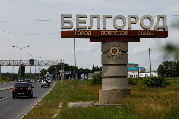 Cars drive past a stele displaying the city name in Belgorod