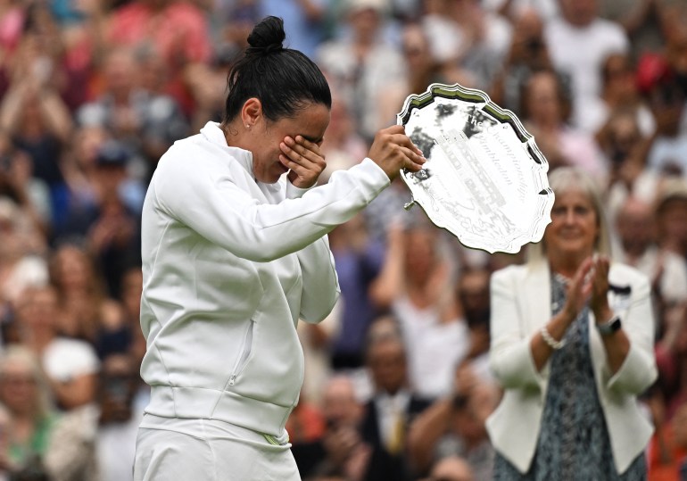 Tennis - Wimbledon - All England Lawn Tennis and Croquet Club, London, Britain - July 15, 2023 Tunisia’s Ons Jabeur with the runners up trophy after losing her final match against Czech Republic's Marketa Vondrousova REUTERS/Dylan Martinez