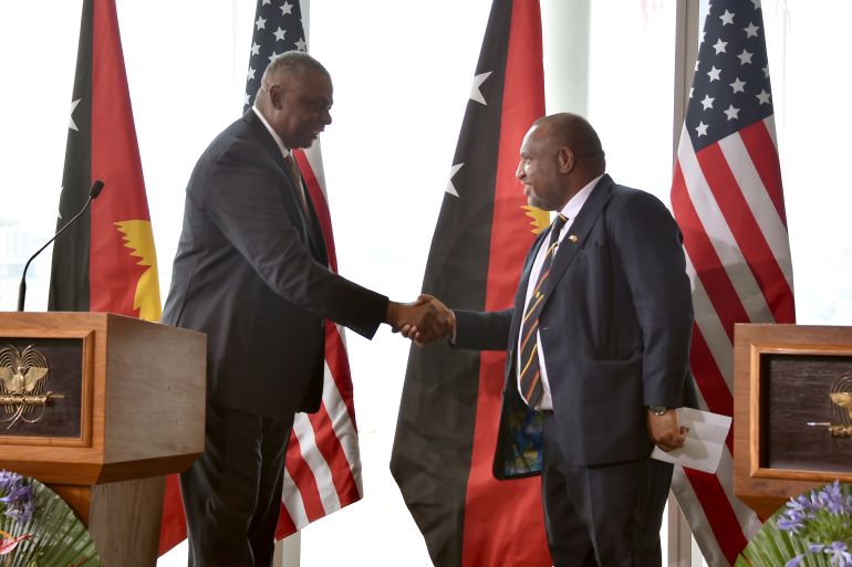 Papua New Guinea's Prime Minister James Marape shakes hands with US Secretary of Defense Lloyd Austin in Port Moresby on July 27, 2023