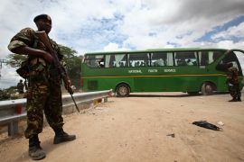 epa04692154 A Kenyan soldier (L) stands guard as rescued university studentsdepart in buses provided by the government to transport them home, from the Garissa military camp, in Garissa town, located near the border with Somalia, some 370km northeast of the capital Nairobi, Kenya, 04 April 2015. Five suspects have been arrested in connection with the killing of 147 people at a Kenyan university campus by al-Shabaab, the Interior Ministry said 04 April. In the deadliest attack yet by al-Shabaab, gunmen stormed the Garissa University campus at dawn on 02 April, gunning down students who they identified as Christians because they could not answer questions about the Koran. EPA/DANIEL IRUNGU