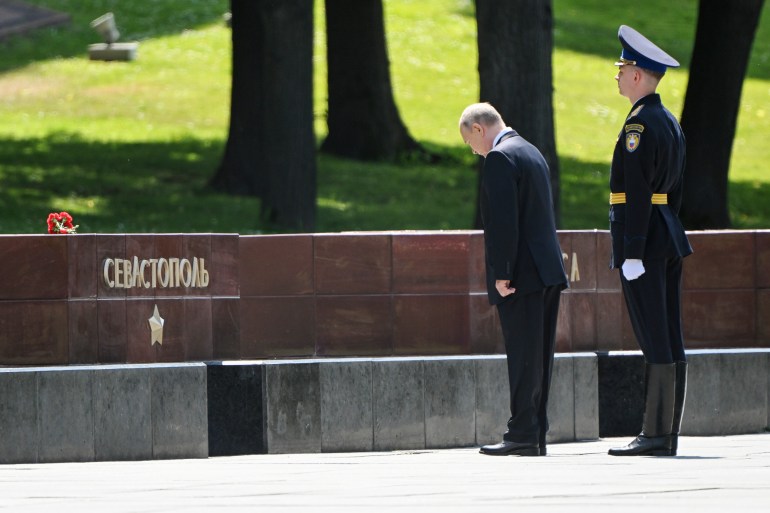 Russian President Vladimir Putin stands at the Sevastopol (City in Crimea) inscription as he attends a wreath-laying ceremony marking the 82nd anniversary of the Nazi German invasion into Soviet Union in World War II on the Remembrance and Sorrow Day at the Tomb of the Unknown Soldier by the Kremlin wall in Moscow, Russia, Thursday, June 22, 2023. (Sergey Guneev, Sputnik, Kremlin Pool Photo via AP)