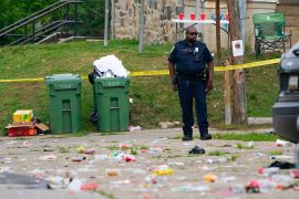A police officer standing near debris left behind as people fled the street party in Baltimore