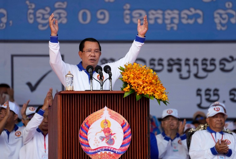 FILE - Cambodia Prime Minister Hun Sen, center, also President of Cambodian People's Party, delivers a speech during his party election campaign in Phnom Penh Cambodia, Saturday, July 1, 2023. Two senior members of Cambodia’s opposition Candlelight Party have been arrested for allegedly teaching voters how to cast a null ballot in this month's general election, becoming the first people to be arrested under the country's recently amended election law. (AP Photo/Heng Sinith, File)