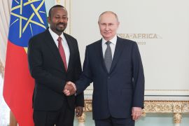 Russian President Vladimir Putin, right, and Ethiopian Prime Minister Abiy Ahmed shake hands during their meeting on the eve of the Russia-Africa Summit in St Petersburg, Russia, Wednesday, July 26, 2023 [TASS News Agency Host Pool Photo via AP]