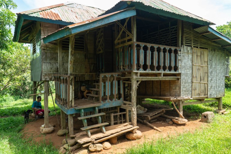 The traditional wooden home of Crispin Tingal's mother. It is elevated on stilts and has steps up to a verandah and front door. Some of the walls are made of bamboo