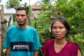 Crispin Tingal’s wife, Dolly, and brother Ramon. They are standing in a village