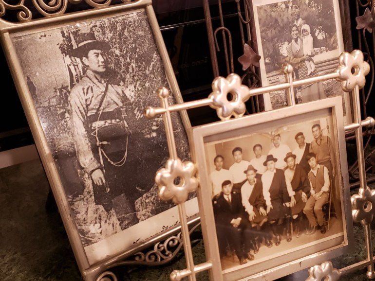 A selection of photos on display in Tsultrim's home, One on the left shows him as a young man when he was a resistance fighter.