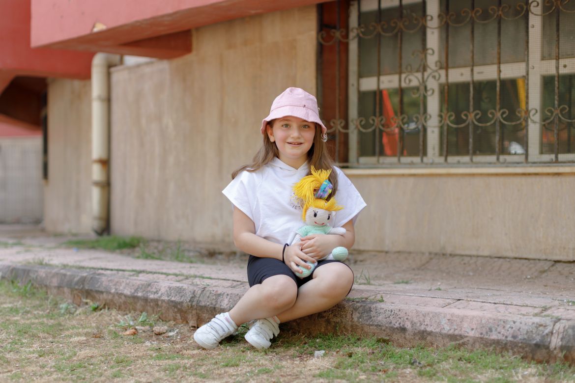 Sare, 9, holds the stuffed doll gifted by her grandfather