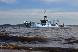 MV K-Palm, the cruise boat which capsized and killed at least 32 people, is salvaged by divers in Lake Victoria near Mutima village, south of Kampala, on November 29, 2018. - Most of the victims were young, affluent Ugandans enjoying a raucous end-of-year party, according to a survivor. (Photo by Stringer / AFP)