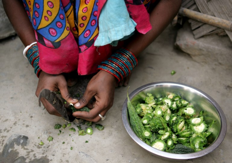 An Indian labourer prepares food