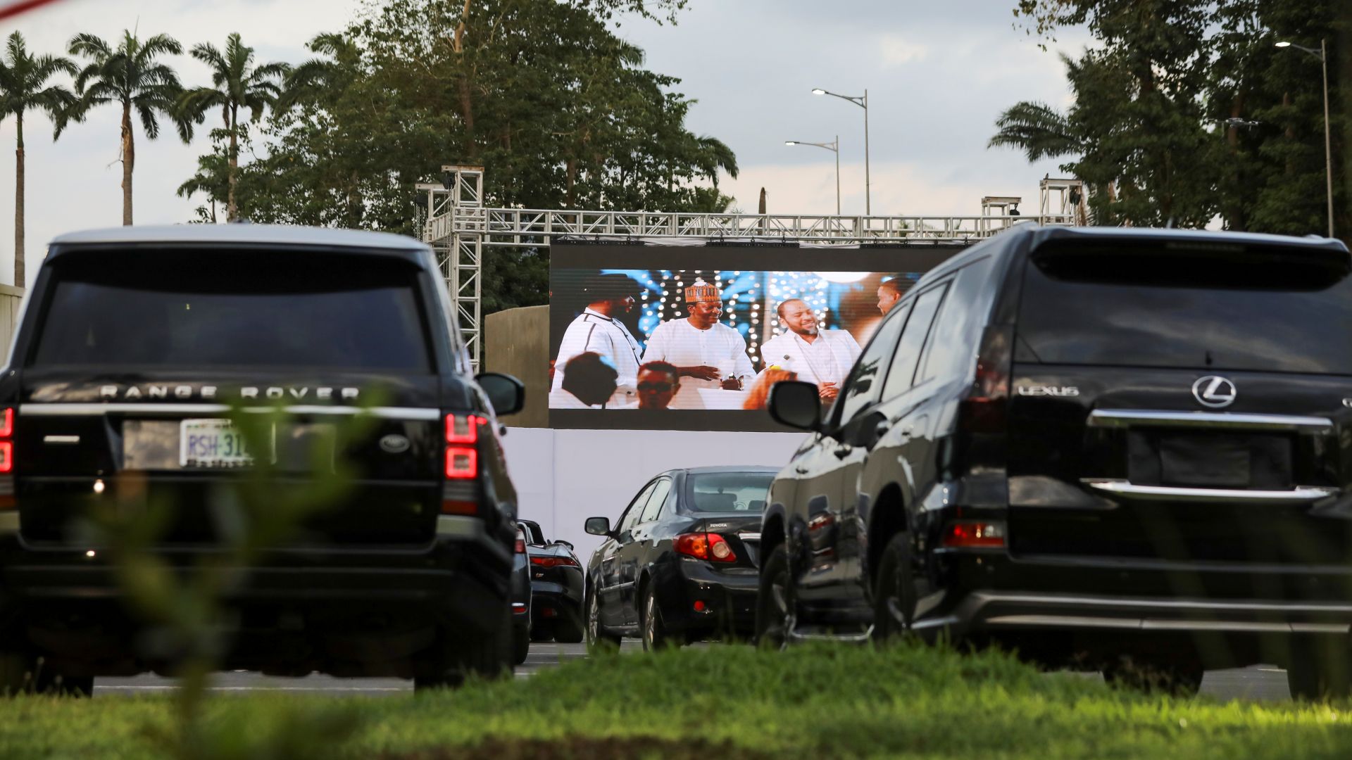 Movie audiences sit in their parked cars as they watch a movie at a drive-in cinema amid the COVID-19 outbreak in Abuja