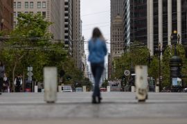 A woman walks along Market street in downtown San Francisco, US, as the city struggles to return to its pre-pandemic downtown occupancy rate