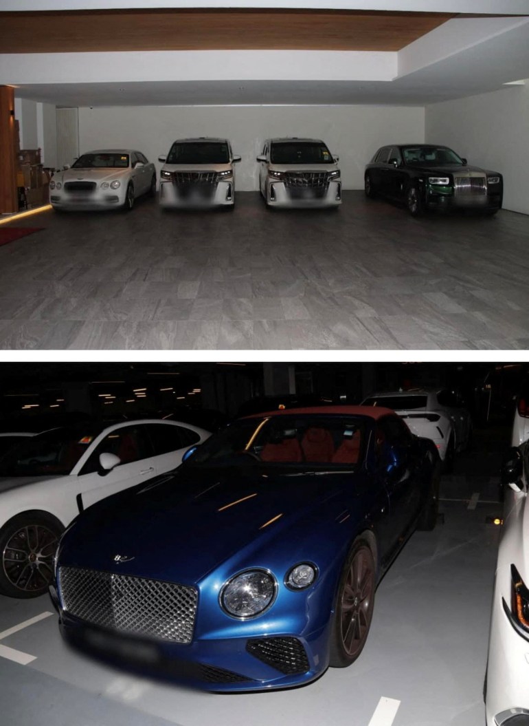 A Rolls Royce and other luxury cars seized by Singapore police. The vehicles are in a garage,