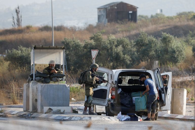 Israeli troops check cars at a checkpoint near a shooting scene in Huwara in the Israeli-occupied West Bank August 19, 2023. REUTERS/Raneen Sawafta