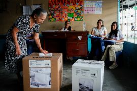 A woman casts her ballot at a polling station during the presidential election in Ecuador