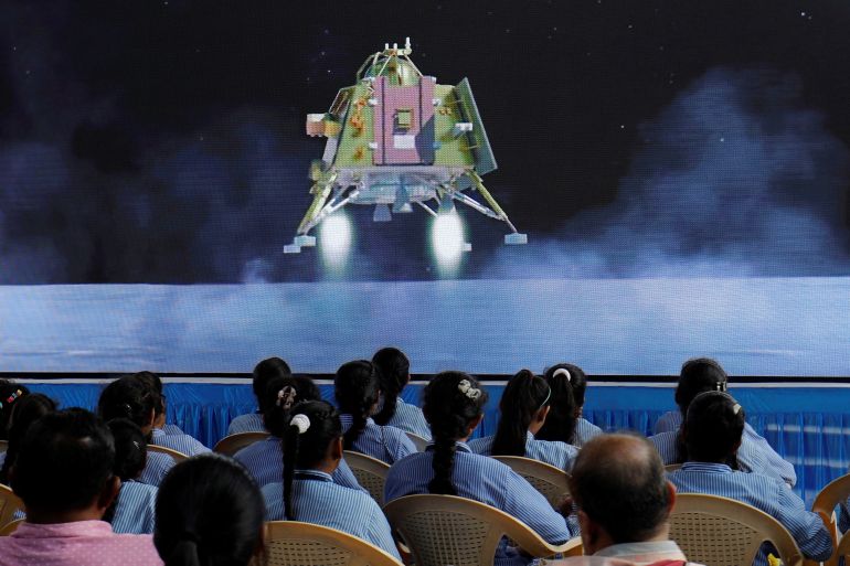 People watch a live stream of Chandrayaan-3 spacecraft's landing on the moon, inside an auditorium of Gujarat Science City in Ahmedabad, India,