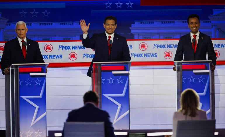 Former US Vice President Mike Pence, Florida Governor Ron DeSantis and Vivek Ramaswamy at podiums on the Republican presidential debate stage