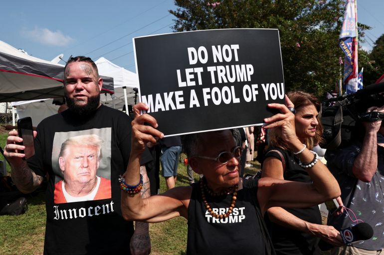 Protester holds a sign that says: Do not let Trump make a fool of you