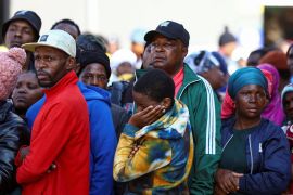People gather at the scene of a deadly blaze, in Johannesburg, South Africa