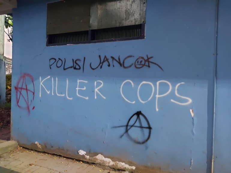 Graffiti on a wall at the Kanjuruhan stadium. The graffiti reads 'Killer cops'