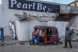 A man walks past a damaged tuk-tuk left outside the site of an attack at the Pearl Beach Hotel in Mogadishu on June 10, 2023. - Somali security forces brought to an end the siege of a hotel in the capital Mogadishu, state media said Saturday, after the Islamist Al-Shabaab group claimed responsibility for the attack. (Photo by Hassan Ali ELMI / AFP) / The erroneous mention[s] appearing in the metadata of this photo by Hassan Ali ELMI has been modified in AFP systems in the following manner: [Pearl Beach] instead of [Palm Beach]. Please immediately remove the erroneous mention[s] from all your online services and delete it (them) from your servers. If you have been authorized by AFP to distribute it (them) to third parties, please ensure that the same actions are carried out by them. Failure to promptly comply with these instructions will entail liability on your part for any continued or post notification usage. Therefore we thank you very much for all your attention and prompt action. We are sorry for the inconvenience this notification may cause and remain at your disposal for any further information you may require.