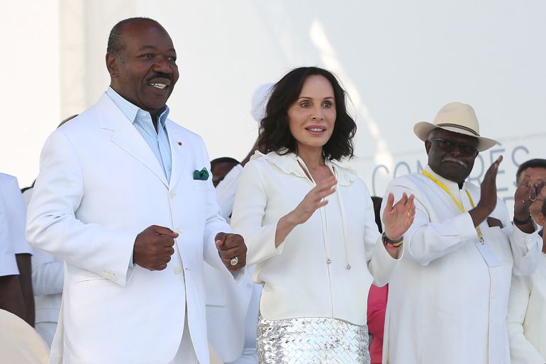 Gabon President Ali Bongo Ondimba (L) and Gabon First Lady Sylvia Bongo Ondimba (2nd L) are seen at the Nzang Ayong stadium in Libreville on July 10, 2023, a day after he announced that he would seek a third term as the oil-rich African nation's head of state. (Photo by Steeve JORDAN / AFP)