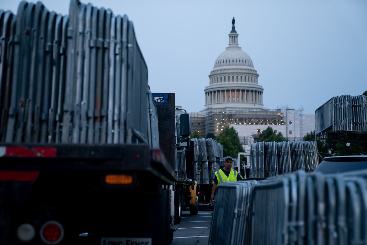 Workers set up security barricades outside the US Capitol
