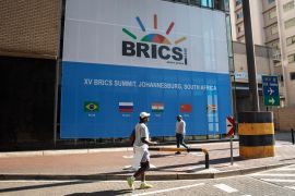 People walk outside the BRICS summit venue in South Africa