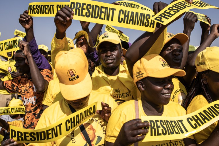 Supporters of opposition leader Nelson Chamisa. They're dressed in yellow shirts and hats and carrying banners reading 'President Chamisa'