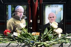 Portraits of Wagner head Yevgeny Prigozhin and commander Dmitry Utkin are seen at a makeshift memorial in front of the PMC Wagner office in Novosibirsk, on August 24, 2023 [Vladimir Nikolayev/AFP]