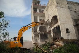 A bulldozer demolishes a Muslim-owned property in Nuh, Haryana, India after violence in the district in early August [Md Meharban/ Al Jazeera]